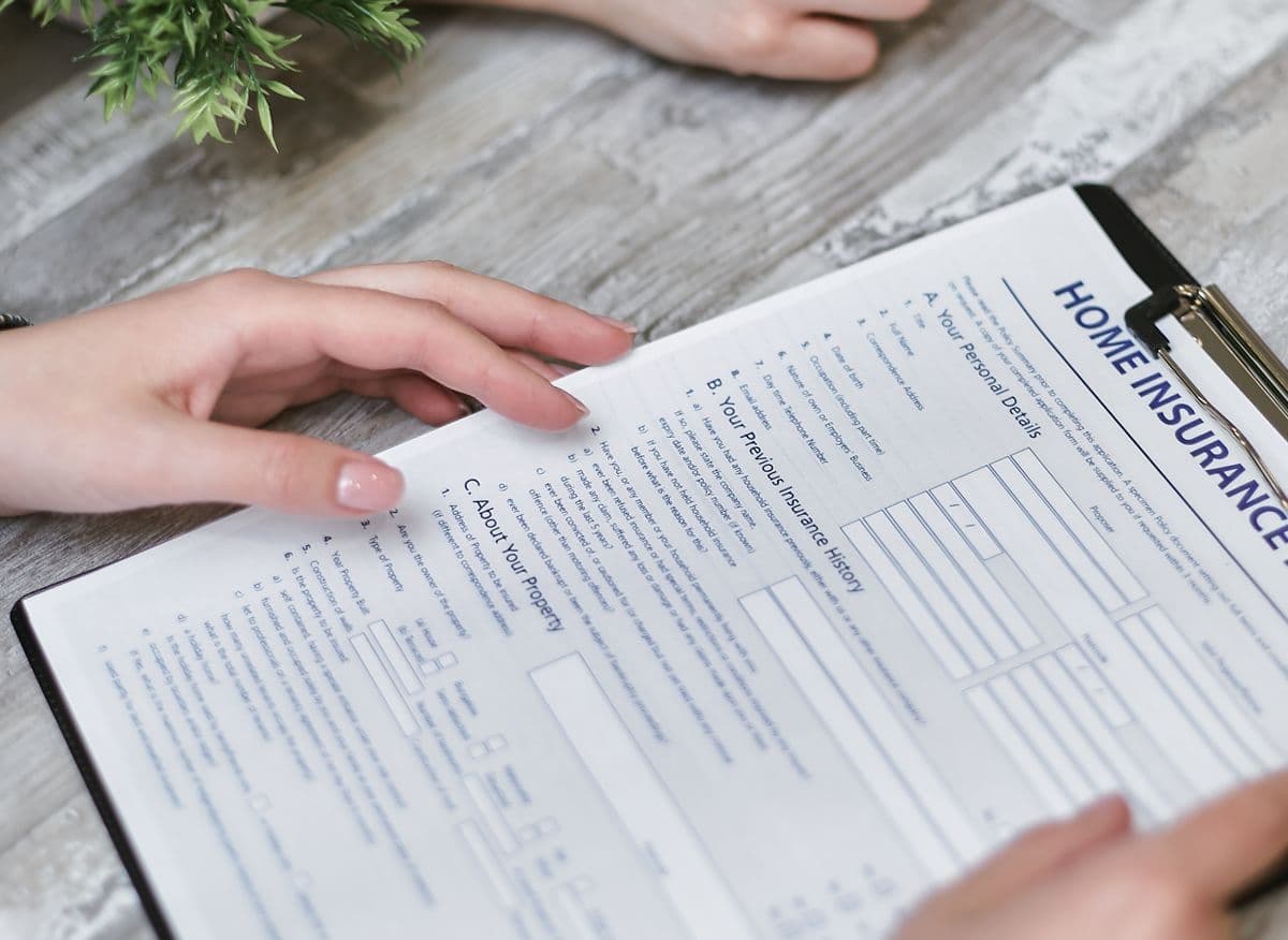 Person searching through documents to find a life insurance policy in the UK