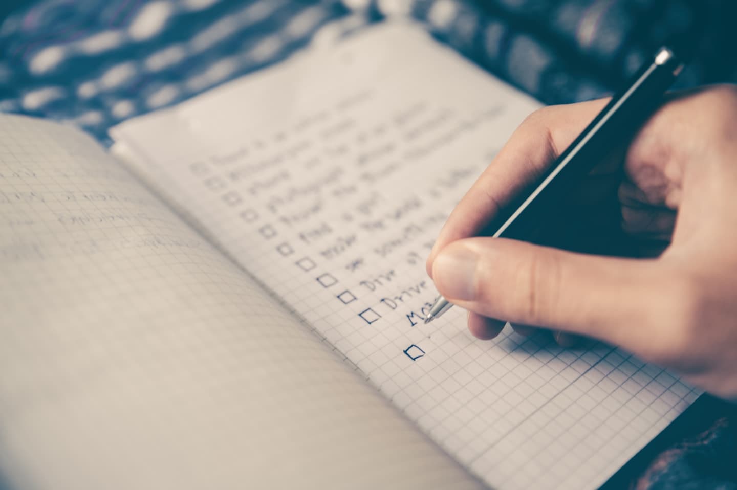 Open notebook and planner used for organising household tasks and important dates, one approach to sharing the mental load