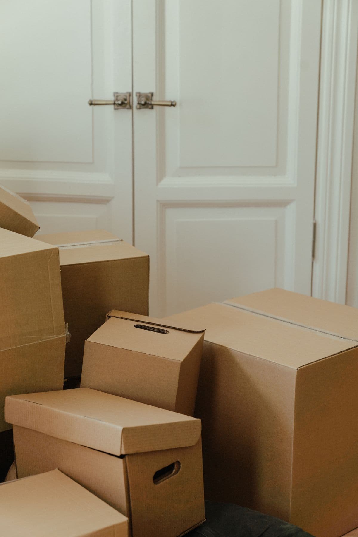 Packed moving boxes in a UK home — a moving house checklist covers the admin side, not just the logistics