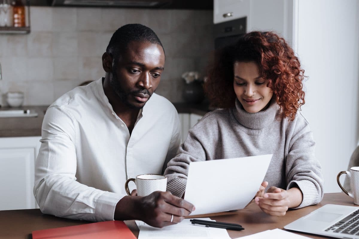 Couple sorting household finances and bills in their shared home in the UK