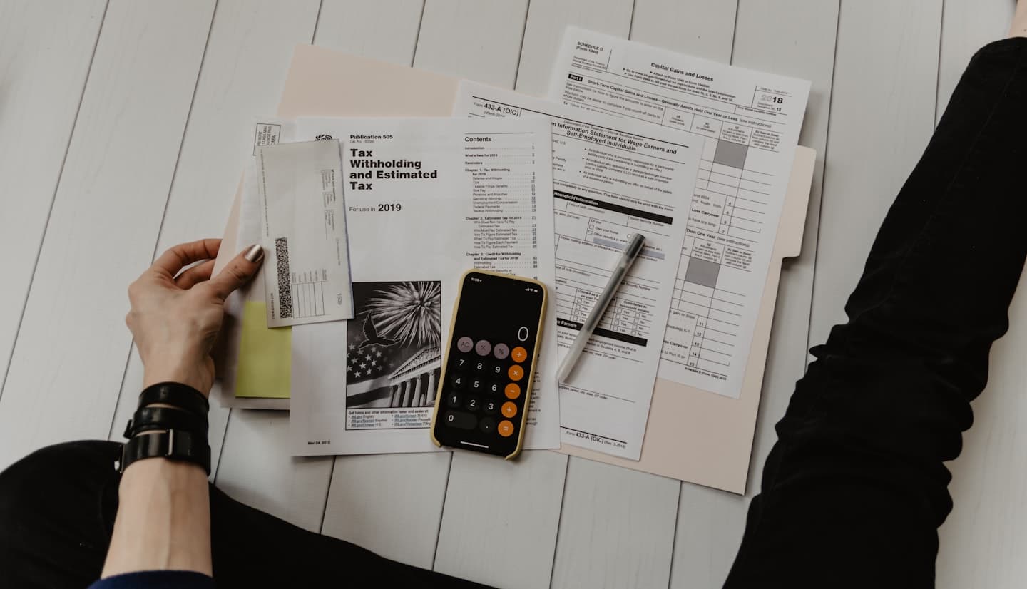 Person reviewing important financial and household documents at home, setting up an organised document system