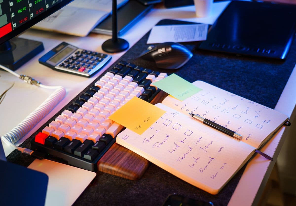 Desk with notebook and checklist — organising home admin with the right productivity app saves time across every renewal and admin task